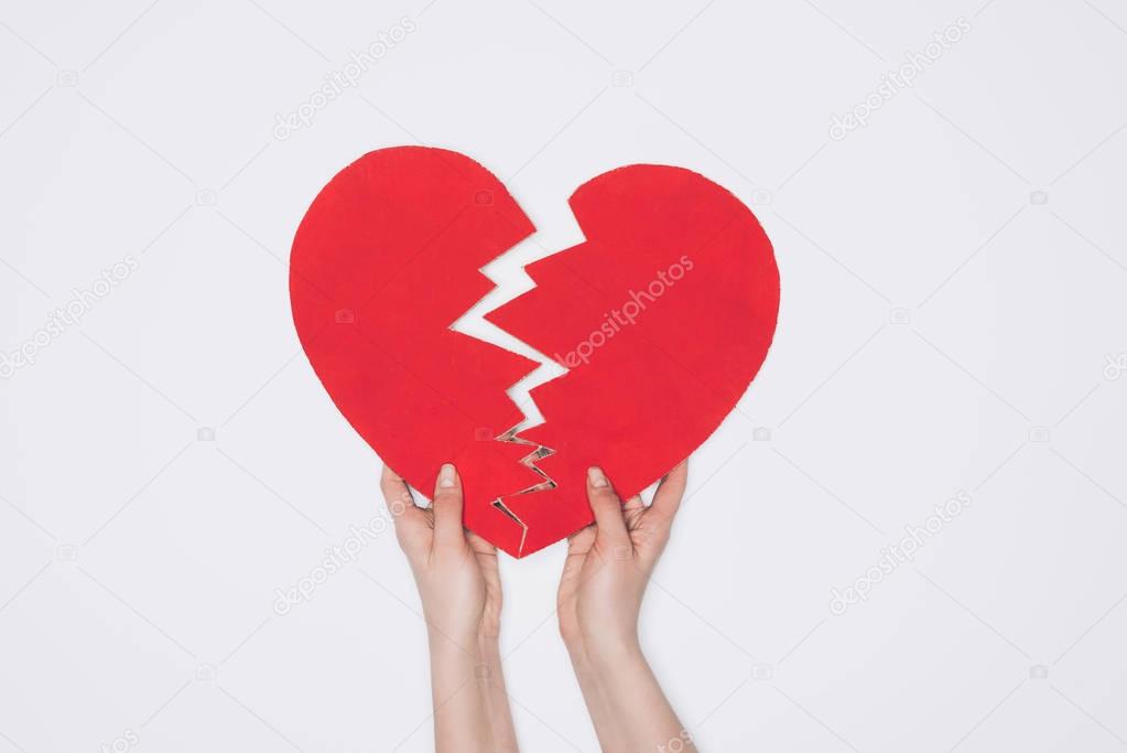 cropped shot of braking red heart isolated on white