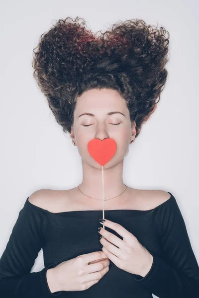 Attractive Young Woman Curly Hair Covering Mouth Red Heart Isolated — Stock Photo, Image