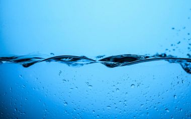 flowing water texture with drops, isolated on blue clipart