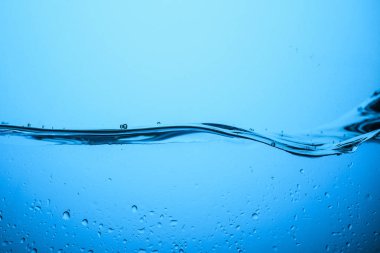 flowing pure water texture with drops, isolated on blue clipart