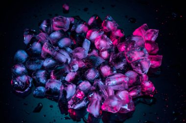 close up of pink melting ice cubes on black clipart