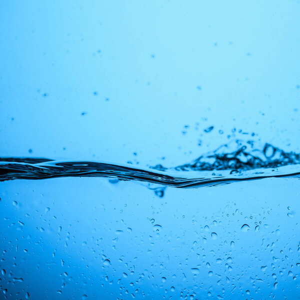 flowing water background with bubbles and drops, isolated on blue
