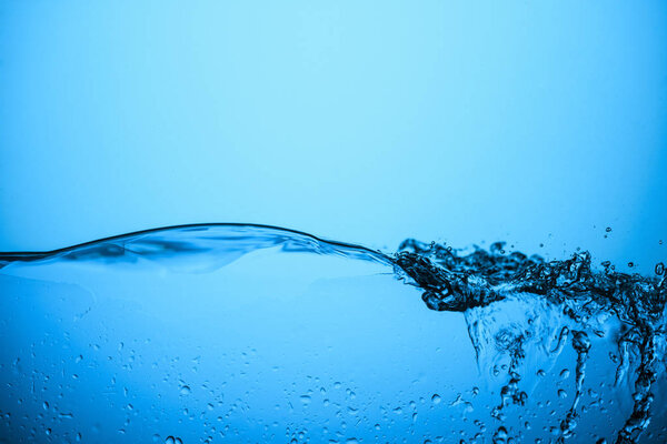 flowing water texture with bubbles and drops, isolated on blue