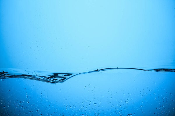 flowing water background with drops, isolated on blue