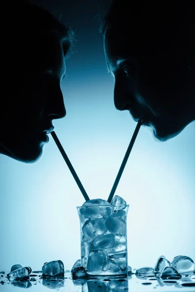 Silhouettes Girls Drinking Cold Water Ice Cubes One Glass Straws — Stock Photo, Image