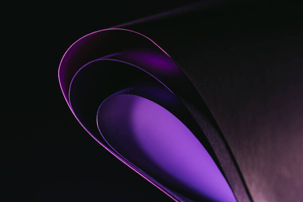 arcs of warping purple paper on black