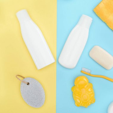 flat lay with bottles of lotion, toothbrush, pumice, soap and bath toy, isolated on blue and yellow clipart