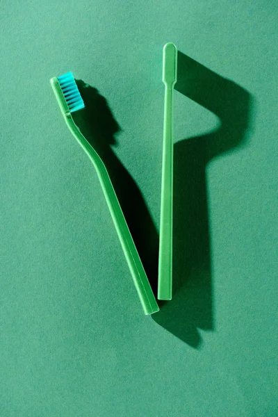 Top View Green Toothbrushes Shadows Green — Free Stock Photo