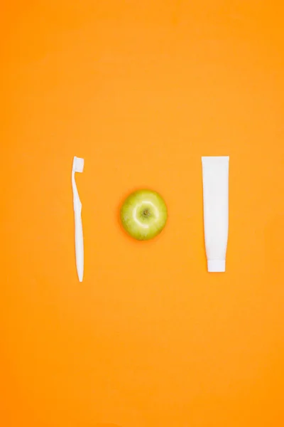 Top View Toothbrush Apple Tube Toothpaste Isolated Orange — Stock Photo, Image