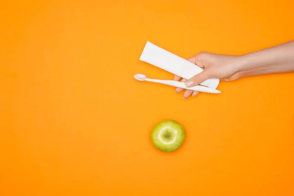 Cropped View Woman Holding Toothbrush Tube Toothpaste Isolated Orange Apple — Stock Photo, Image