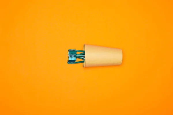 Top View Toothbrushes Paper Cup Isolated Orange — Stock Photo, Image