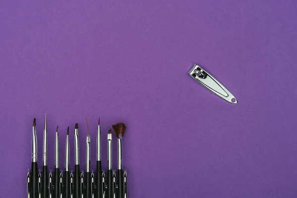Top View Brushes Nail Nippers Isolated Purple — Free Stock Photo