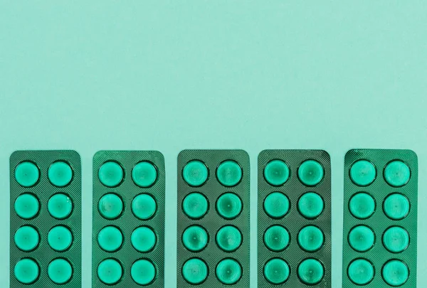 top view of medicines isolated on green backdrop