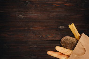 ahşap masa, bakkal kavramı üzerinde ekmek ve makarna alışveriş çantası Üstten Görünüm