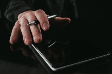 cropped shot of businessman using digital tablet clipart