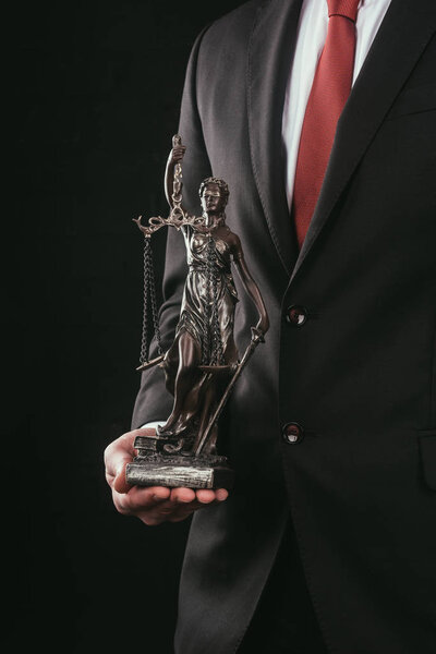 cropped shot of lawyer holding themis sculpture isolated on black