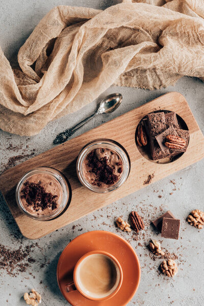 top view of sweet tasty chocolate dessert and cup of coffee on grey 