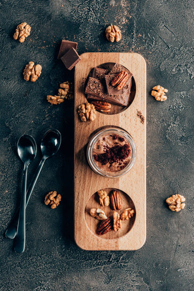 top view of sweet delicious chocolate desserts with nuts on black 
