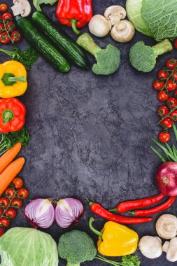 top view of fresh raw healthy organic vegetables on black clipart