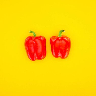 top view of fresh red paprika peppers isolated on yellow clipart