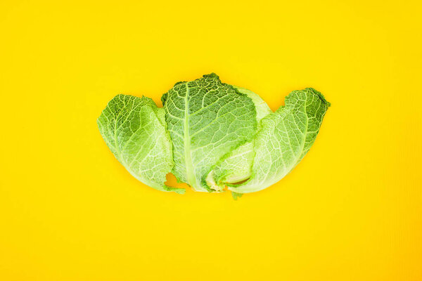 top view of fresh healthy savoy cabbage isolated on yellow