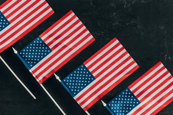 top view of arranged american flags on dark surface, presidents day concept
