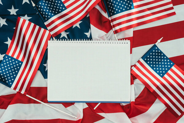 top view of arranged american flags and blank notebook, presidents day concept