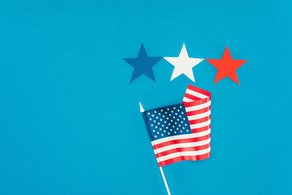 flat lay with arranged american flag and stars isolated on blue, presidents day concept