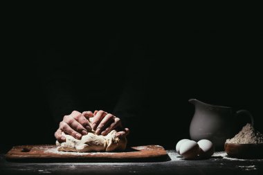 cropped shot of person preparing dough on black clipart