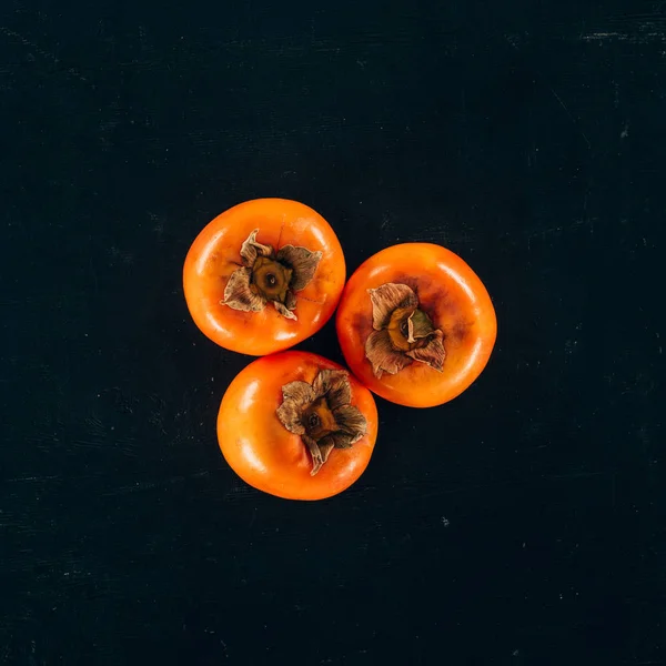 Top View Three Persimmons Isolated Black — Stock Photo, Image