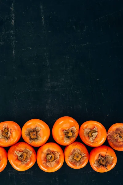 Top View Rows Ripe Yummy Persimmons Black — Stock Photo, Image