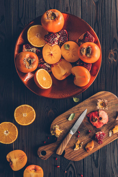 top view of cut fruits and wooden board on table