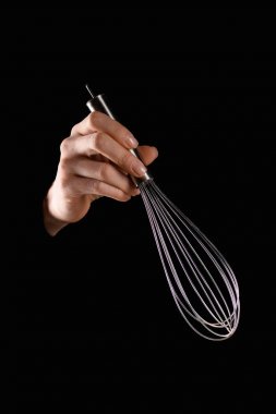 cropped image of woman holding whisk isolated on black clipart
