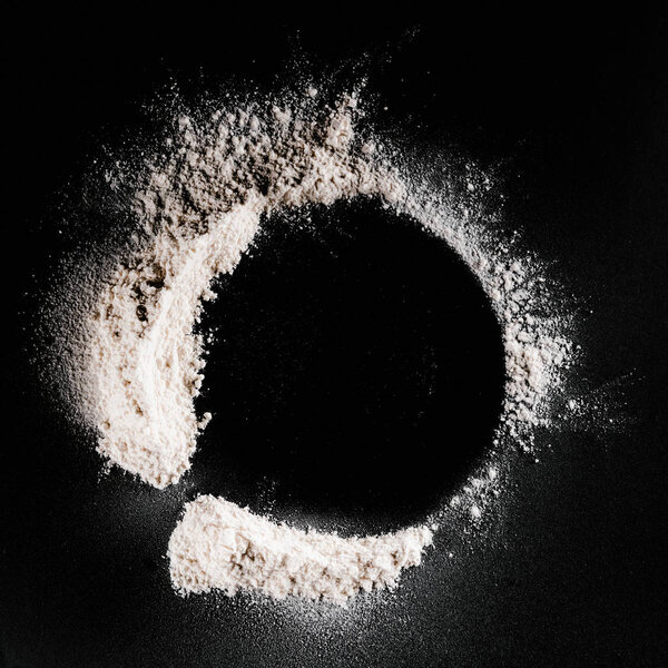 top view of flour on black surface