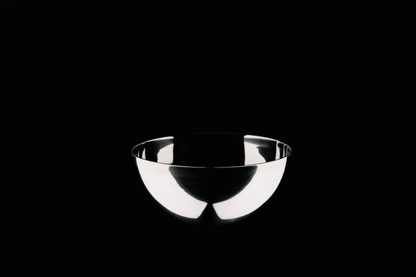 one empty shining bowl isolated on black