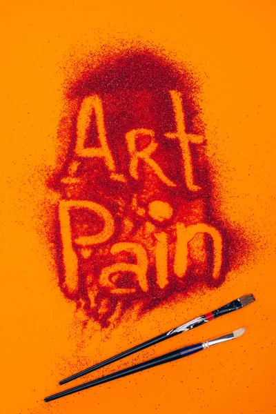 Top View Art Pain Sign Made Red Sand Brushes Isolated — Free Stock Photo