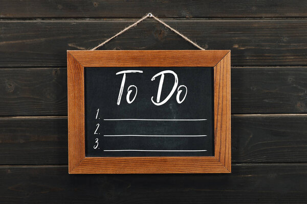 Доска с наклоном висит на деревянной стене
 