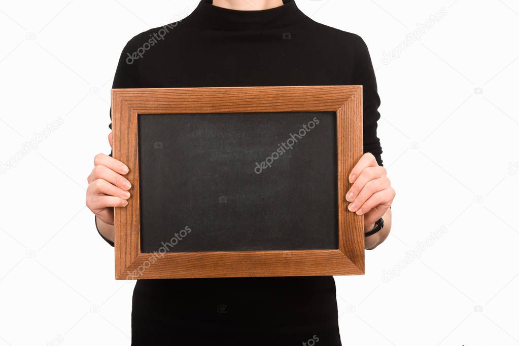 Cropped image of woman holding empty wooden board isolated on white