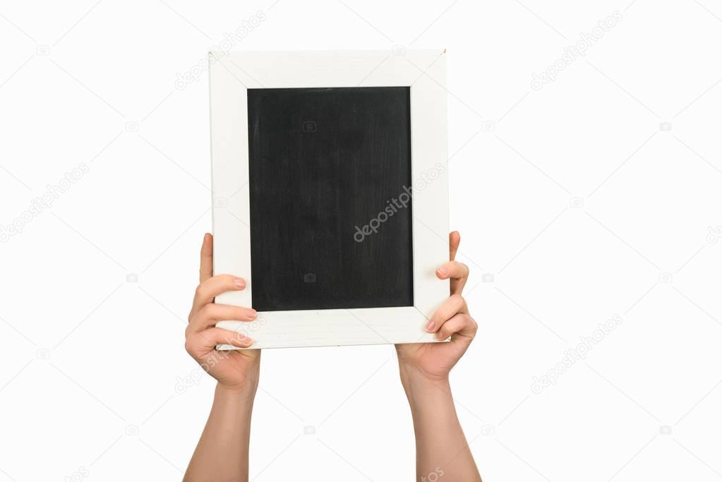 Cropped view of woman holding empty chalkboard isolated on white