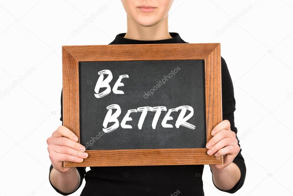 Cropped view of woman holding chalkboard with leteering be better isolated on white