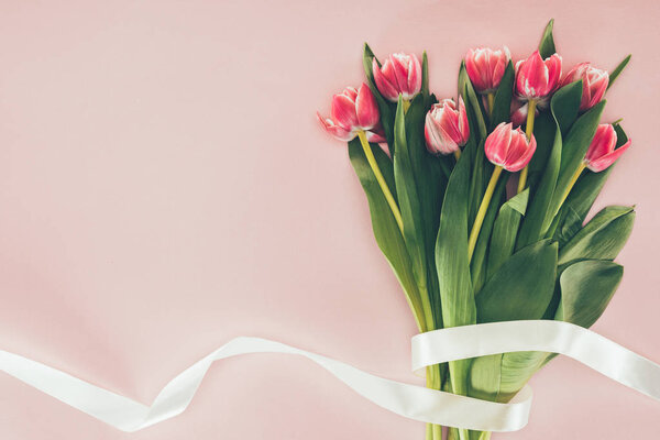 Bouquet of beautiful pink tulips with green leaves and ribbon on pink — Stock Image Bouquet Beautiful Pink Tulips Green Leaves Ribbon Pink Stock Picture