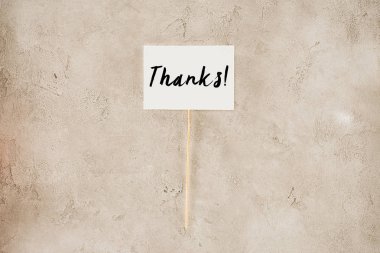 top view of thanks lettering on placard on concrete surface clipart
