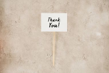 top view of thank you lettering on placard on concrete surface clipart