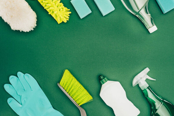 top view of cleaning supplies isolated on green