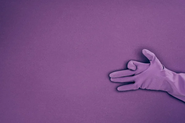 kadının violet izole kauçuk koruyucu eldiven el işaretiyle gösterilen kırpılmış görüntü