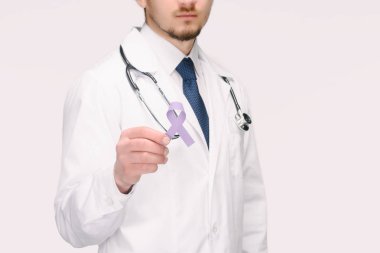 cropped shot of doctor with stethoscope showing purple awareness ribbon for general cancer awareness, Lupus awareness, drug overdose, domestic violence symbol isolated on white clipart