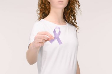 cropped shot of woman showing purple awareness ribbon for general cancer awareness, Lupus awareness, drug overdose, domestic violence symbol in hand isolated on white clipart