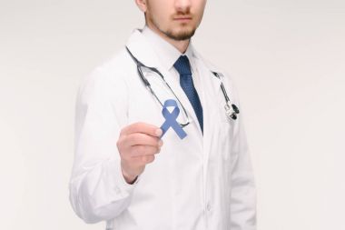 cropped shot of doctor with stethoscope showing blue ribbon isolated on white, prostate cancer concept clipart