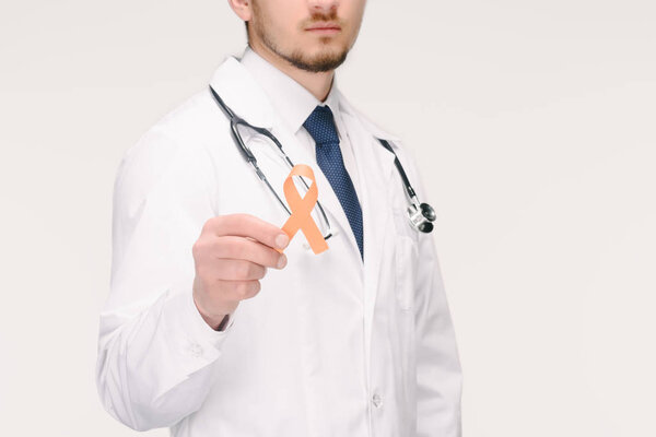 cropped shot of doctor with stethoscope showing orange leukemia, kidney cancer, multiple sclerosis RSD awareness ribbon isolated on white