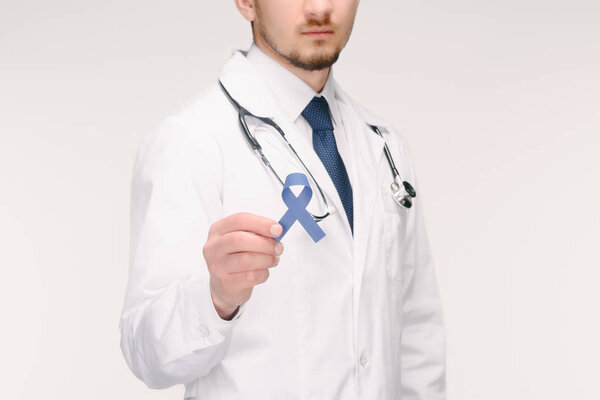 cropped shot of doctor with stethoscope showing blue ribbon isolated on white, prostate cancer concept